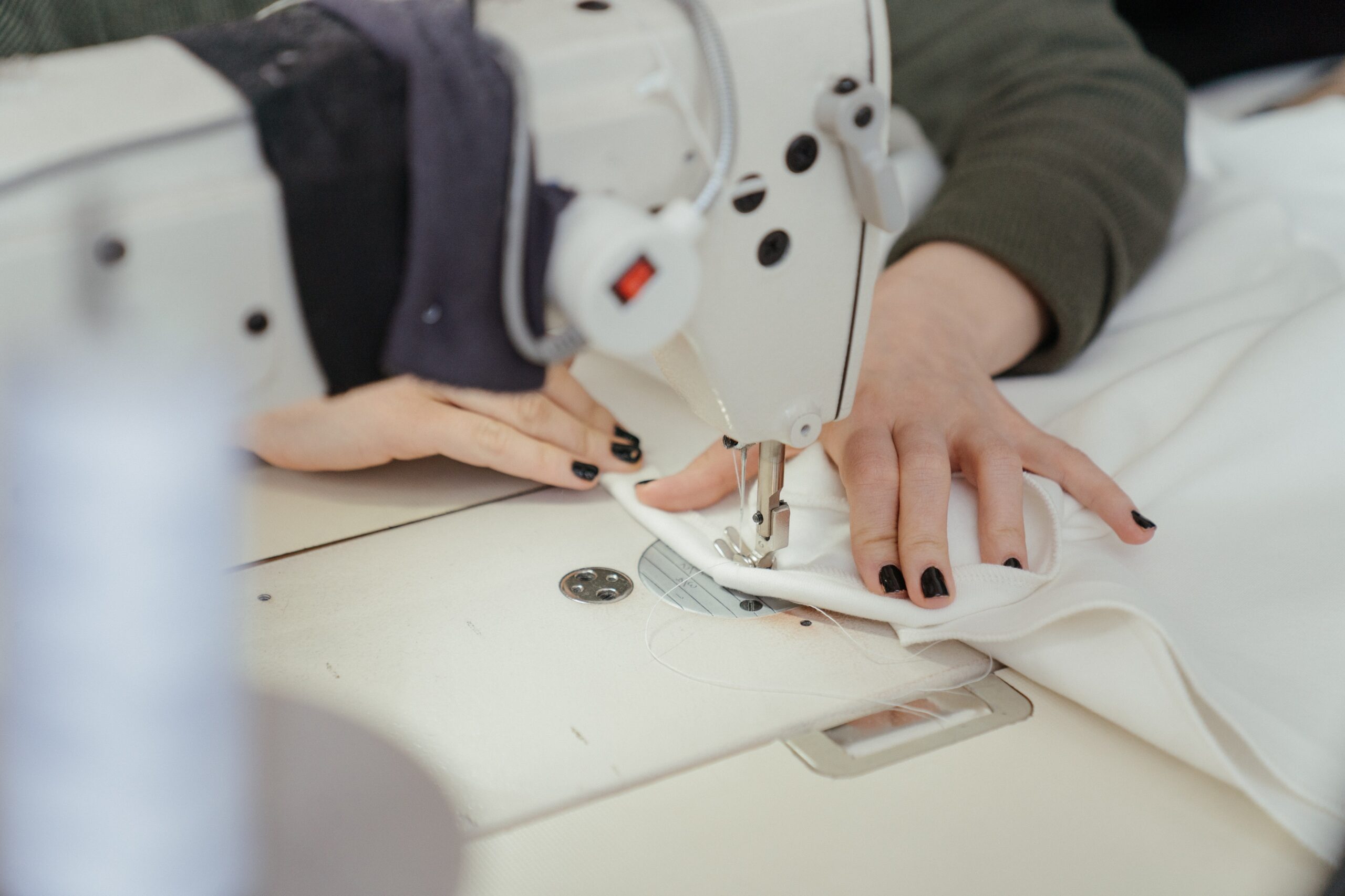 Person in white sewing machine