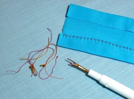 Seam ripper and unpicked thread