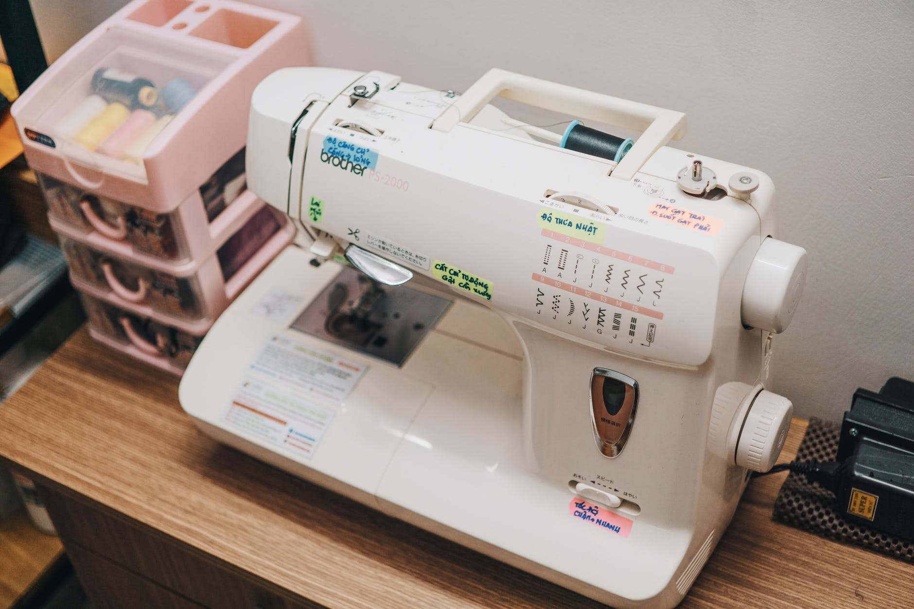 White sewing machine with a pink organizer