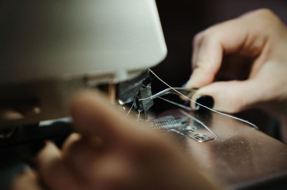 a close up of a person sewing