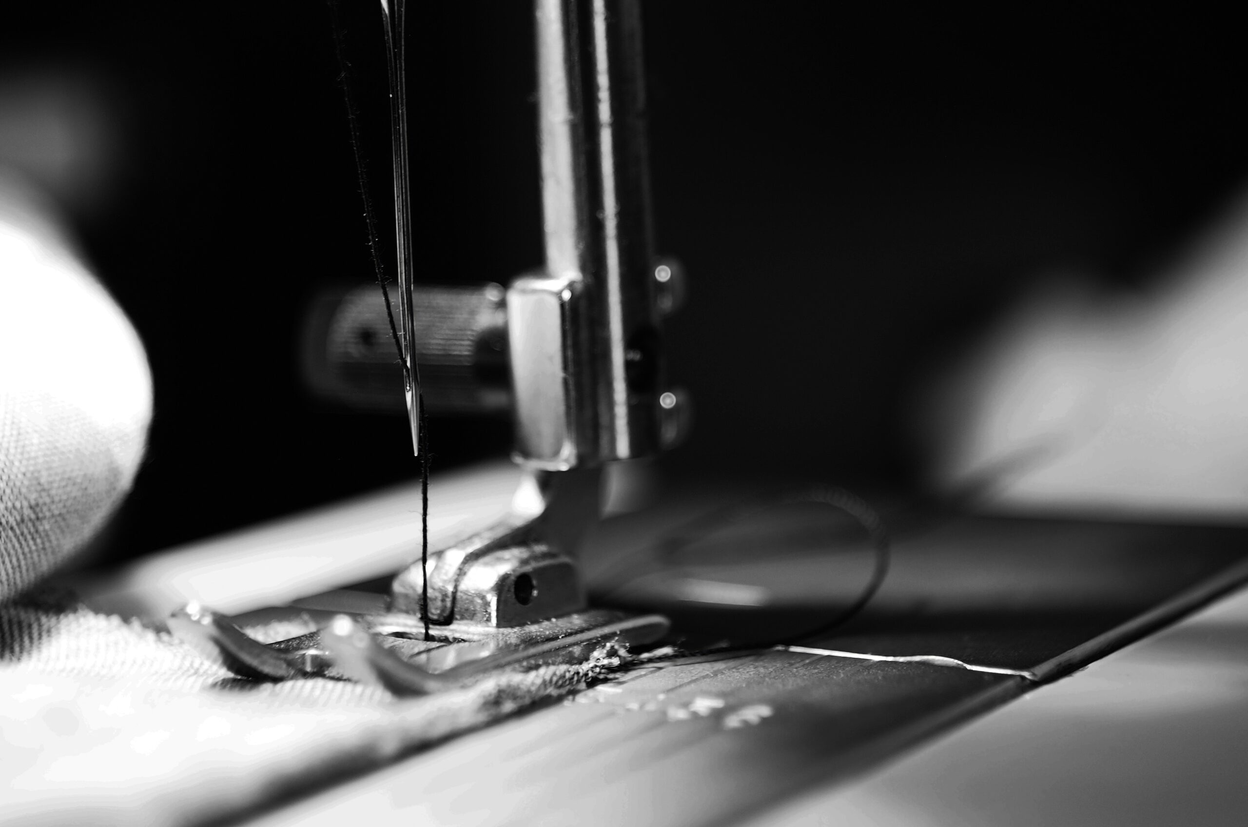 Black and white image of a sewing machine needle
