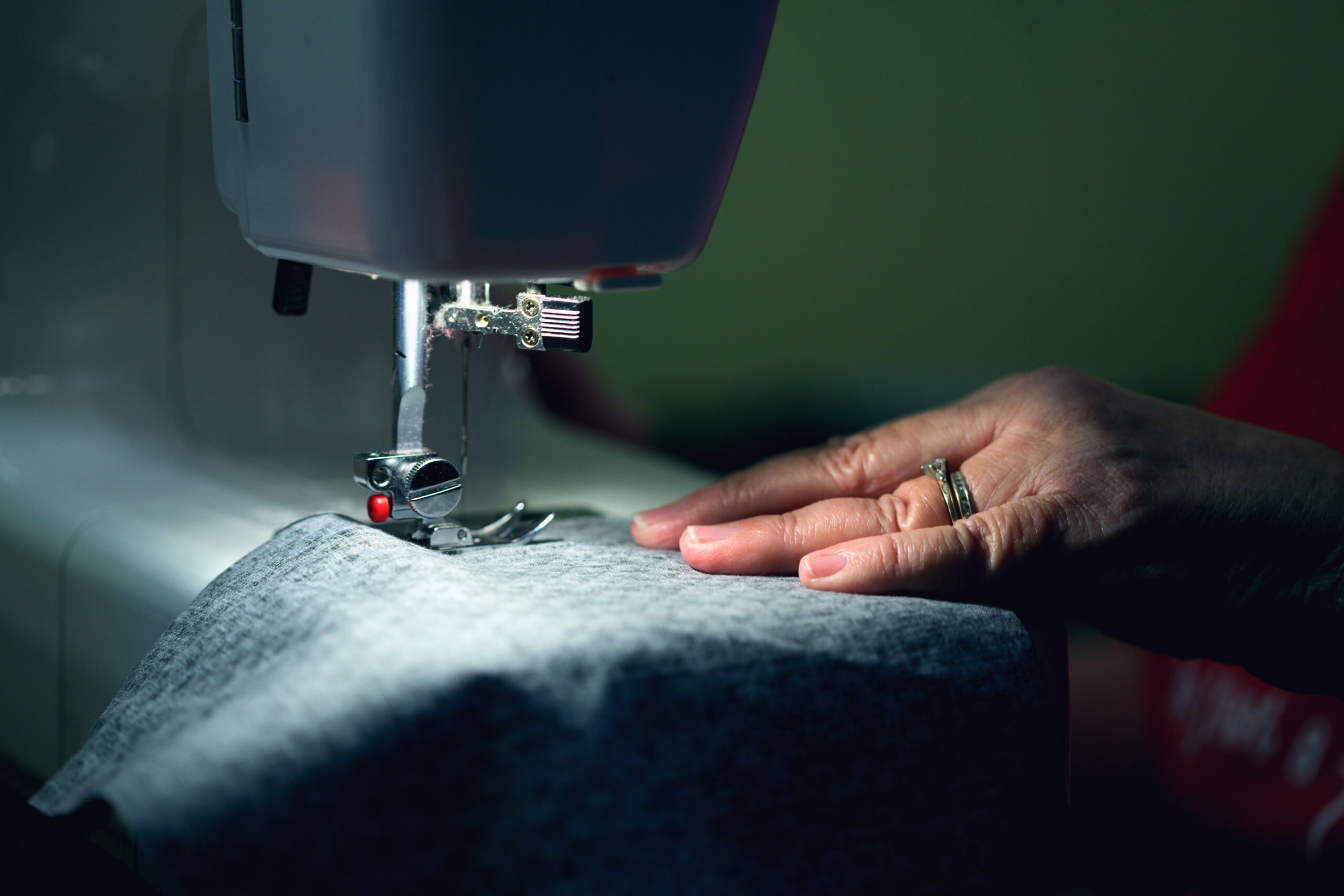Person in gray shirt sewing photo