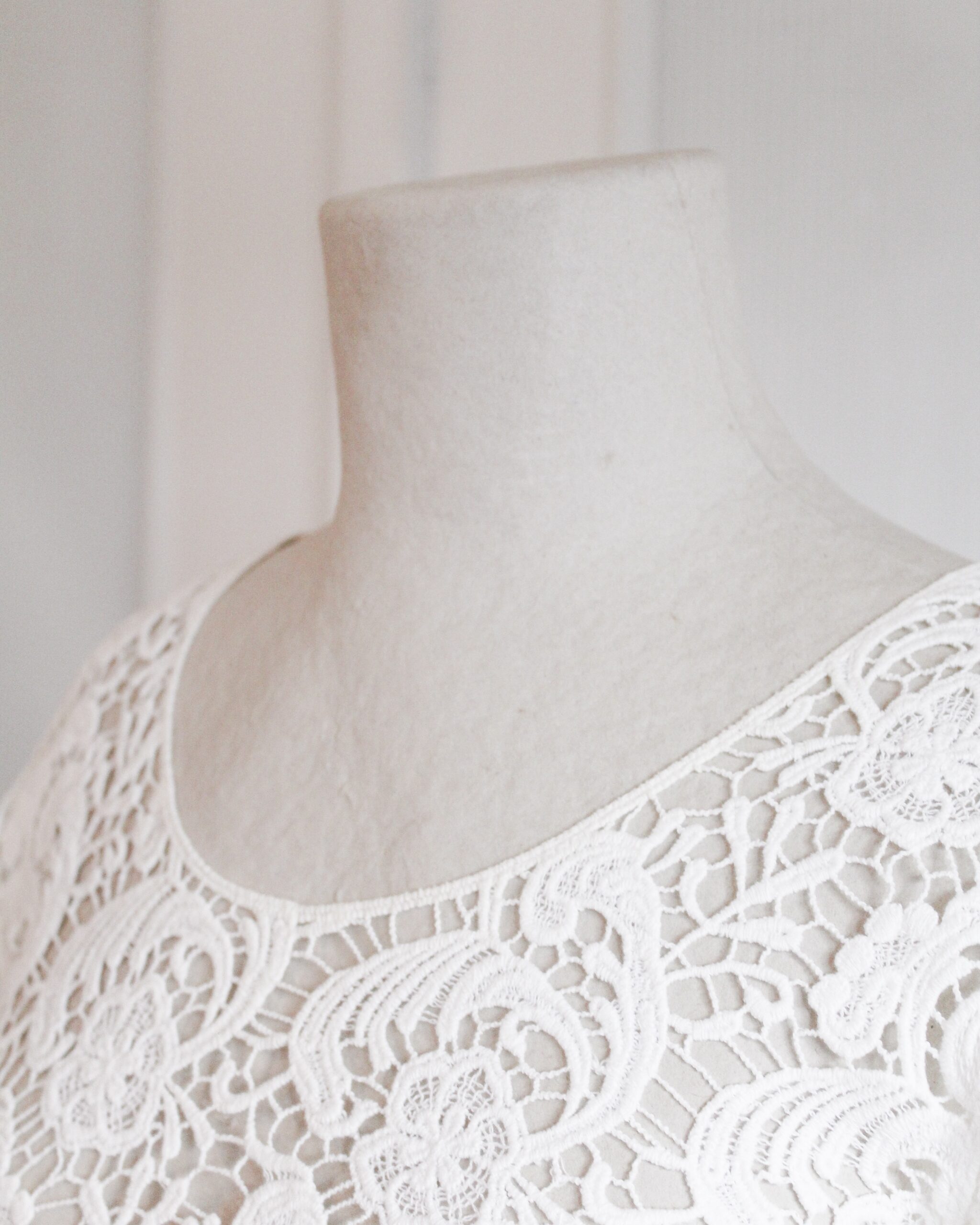 White floral lace shirt in a mannequin